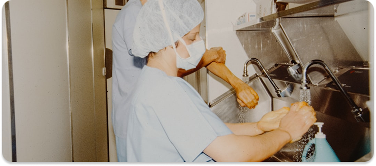 Medical staff practicing hand scrubbing at a sink